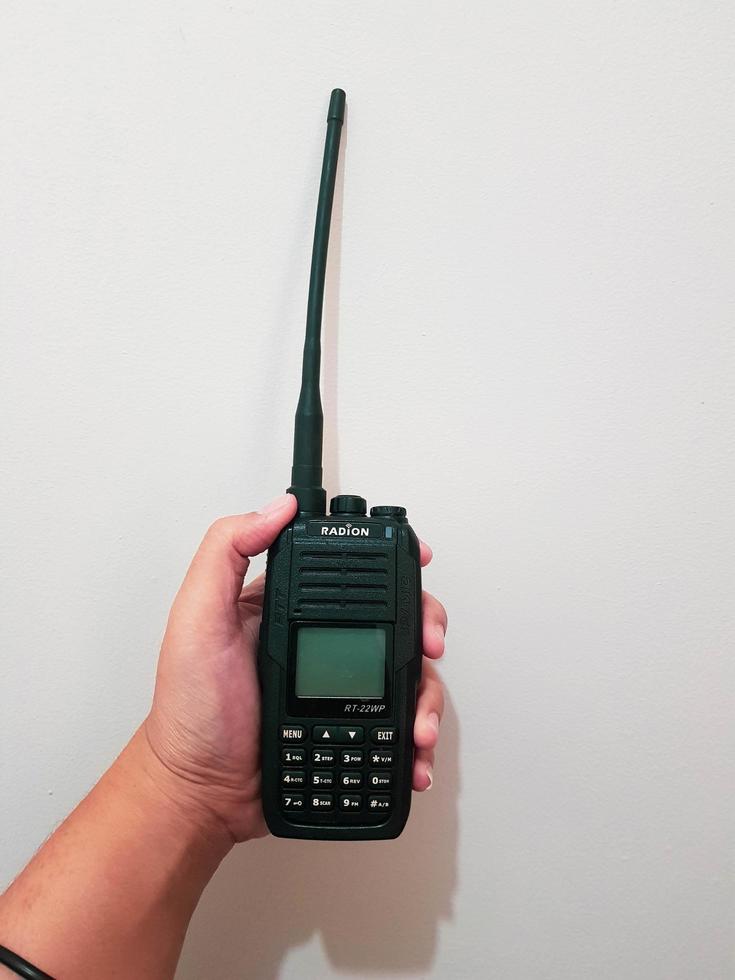 Jakarta, Indonesia in July 2022. A hand holds a handy talkie. photo