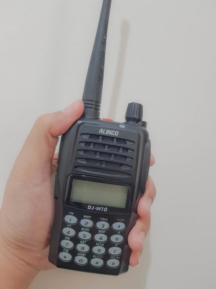 Jakarta, Indonesia in July 2022. A hand holds a handy talkie. photo
