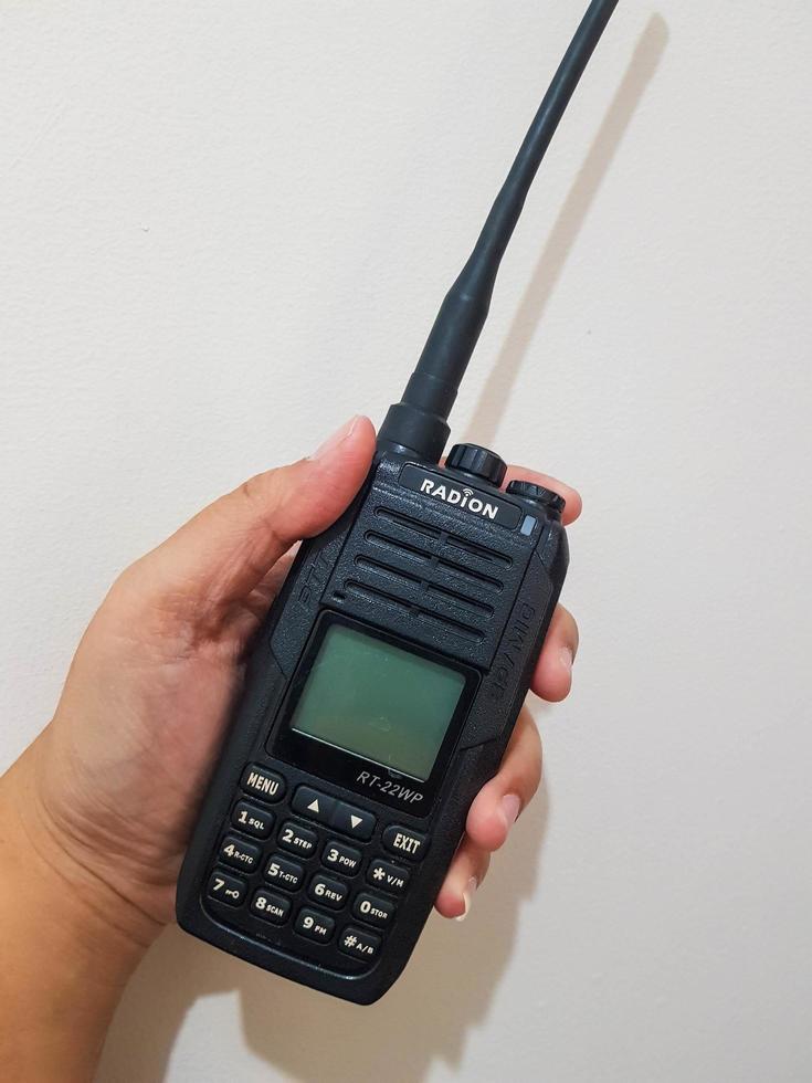 Jakarta, Indonesia in July 2022. A hand holds a handy talkie. photo