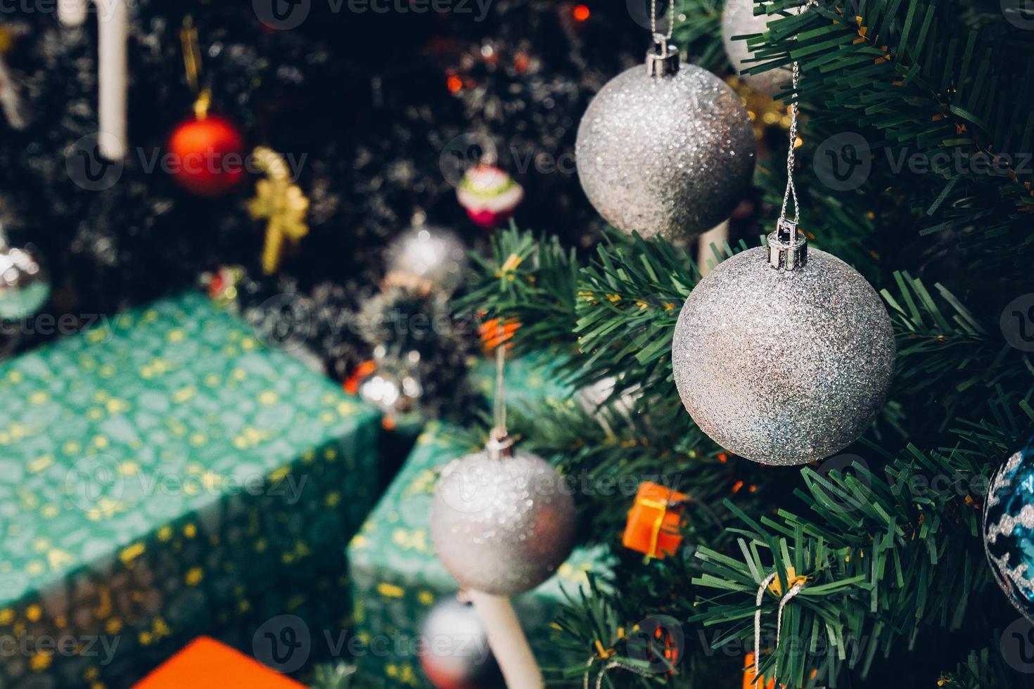 Decorated Christmas tree with colorful bauble on sparkling bokeh light blurred background photo