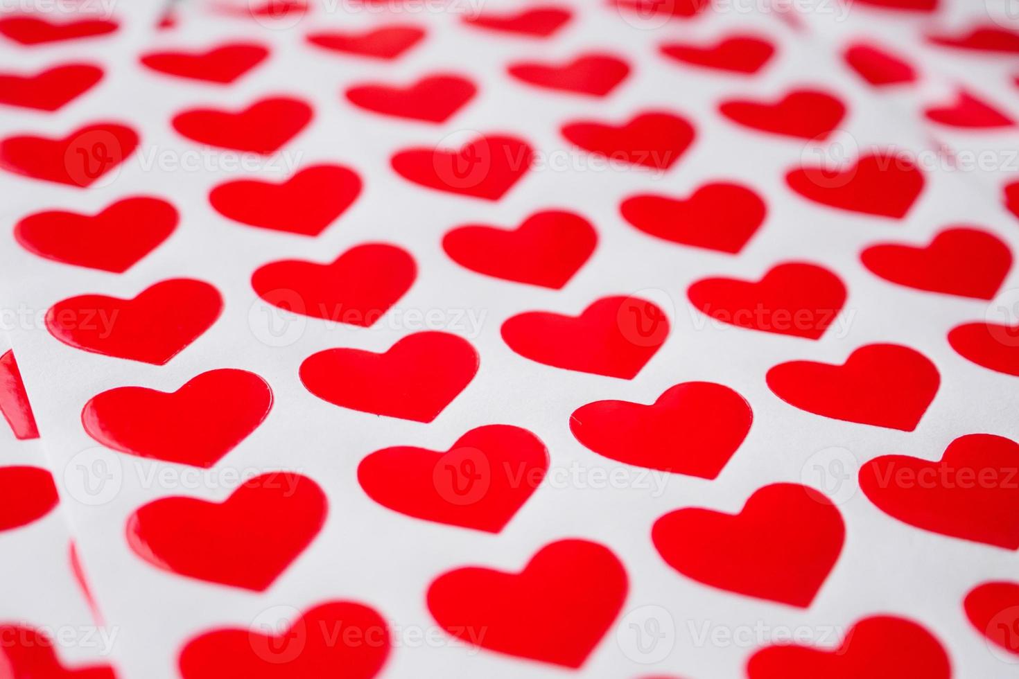 Close up red heart sticker on white paper photo