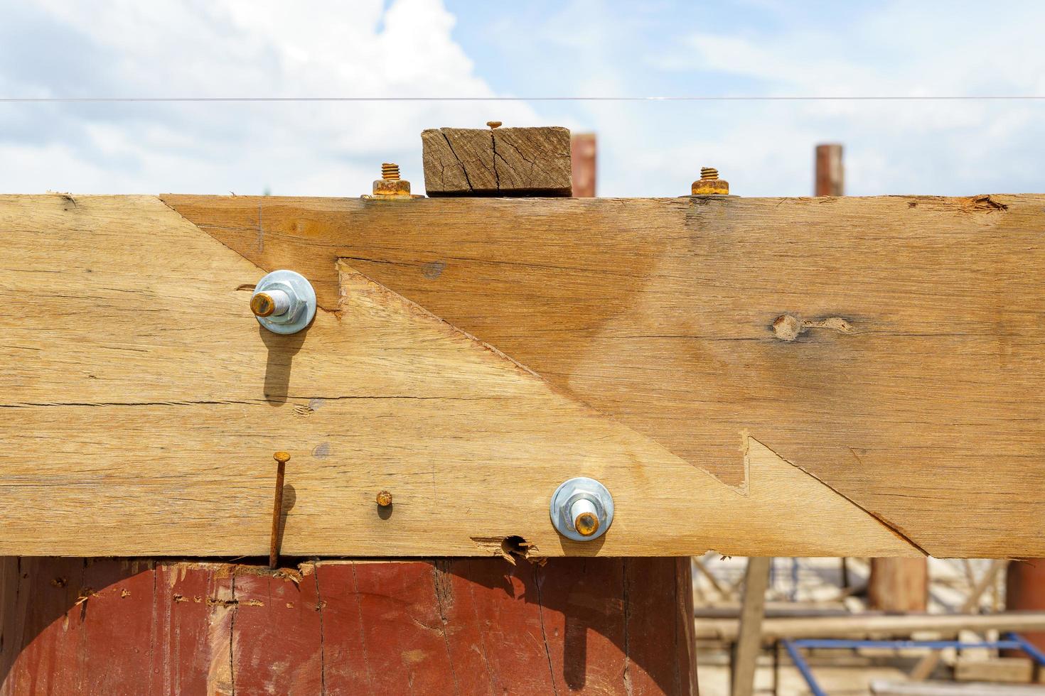 Two wooden joints joined together to provide strength and bolts for a wooden house structure
