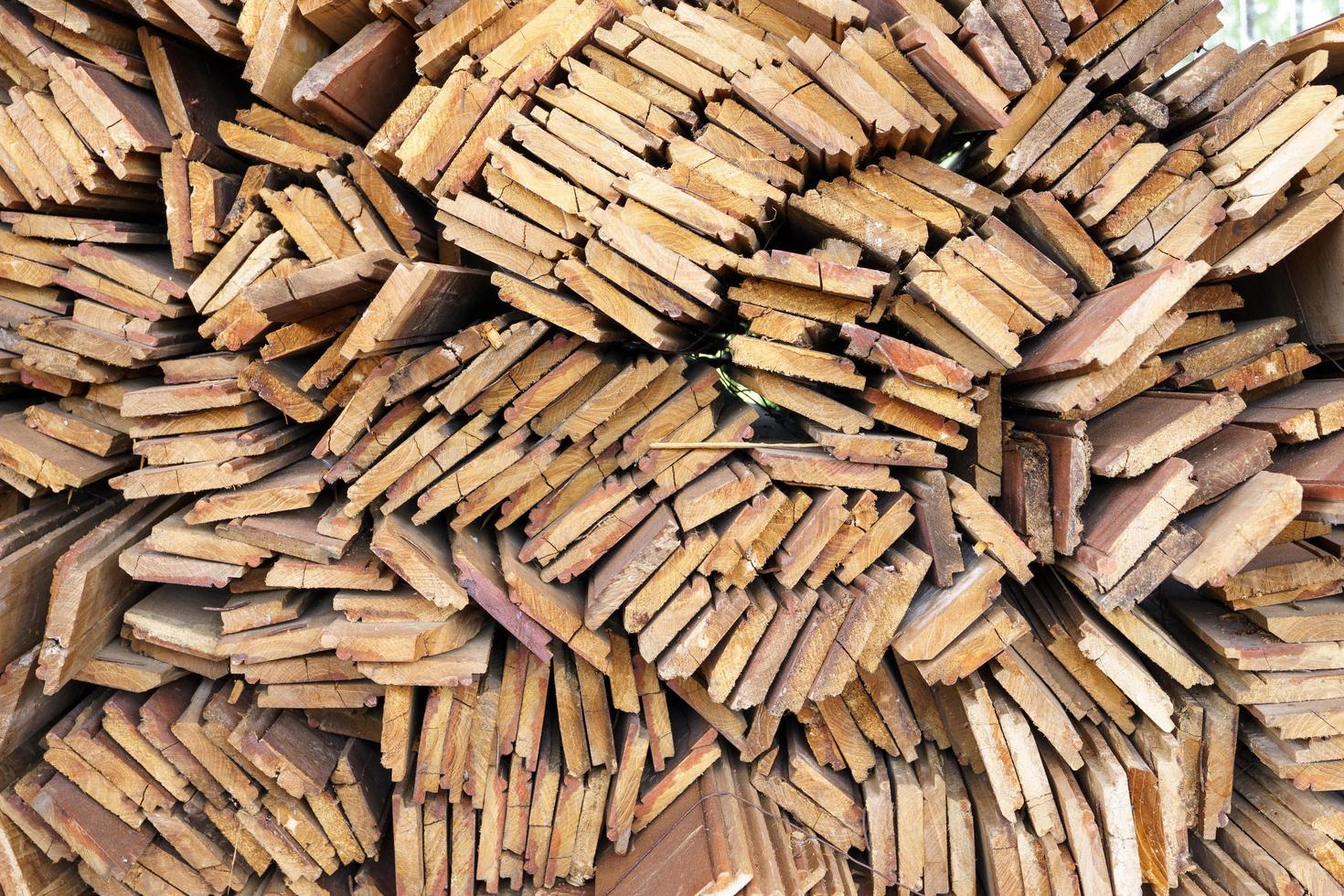 irregularly stacked timber abstract background, Old wooden boards preparing for the construction of the house, Pattern on the edge of several pieces of wood photo