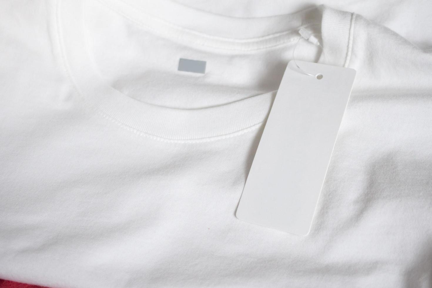 Blank price tag label on white t-shirt photo