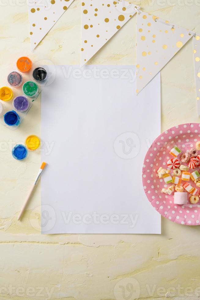 Party management and organization concept with sweets, confetti and blank pages. Creative celebration flat lay with copy space. photo