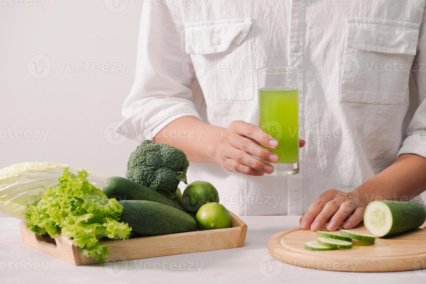 Market. Healthy vegan food. Fresh vegetables, berries, greens and fruits in wooden tray cucumbers radish green peas ... white table. In man hands copy space photo