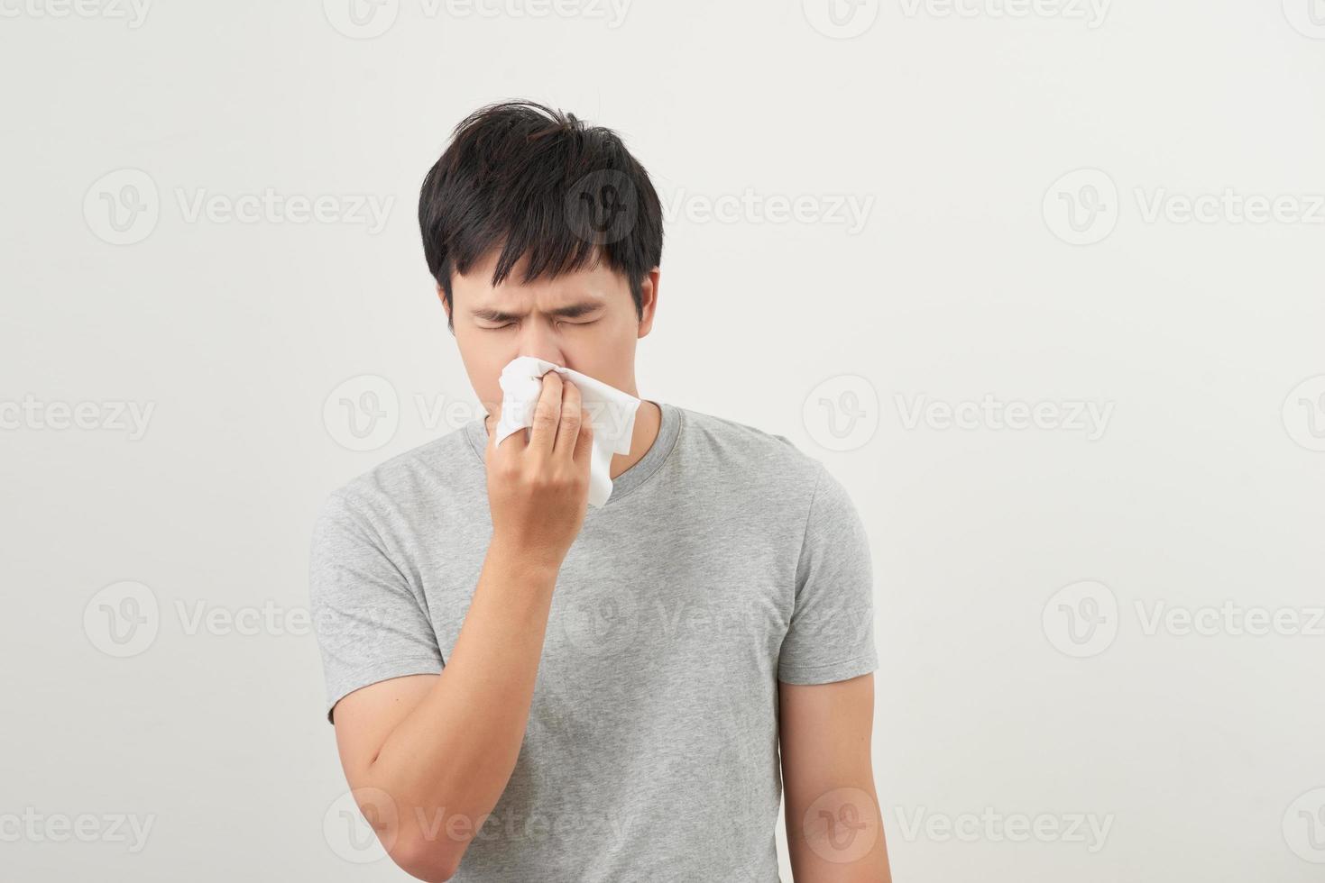 man is sick and sneezing with white background, asian photo