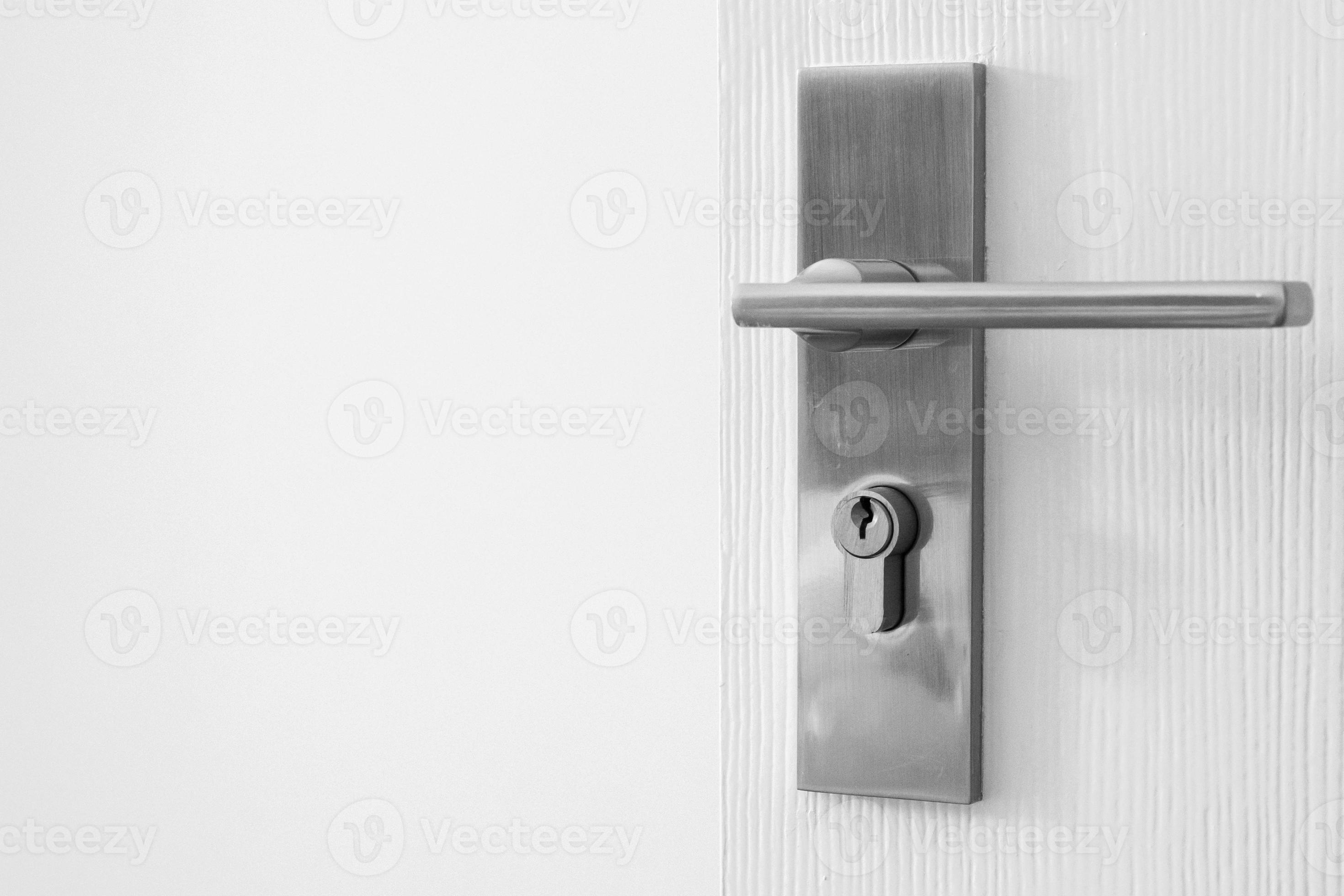 Modern door handle with keyhole on white door 12726667 Stock Photo at
