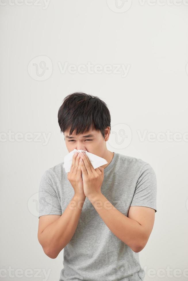 man is sick and sneezing with white background, asian photo
