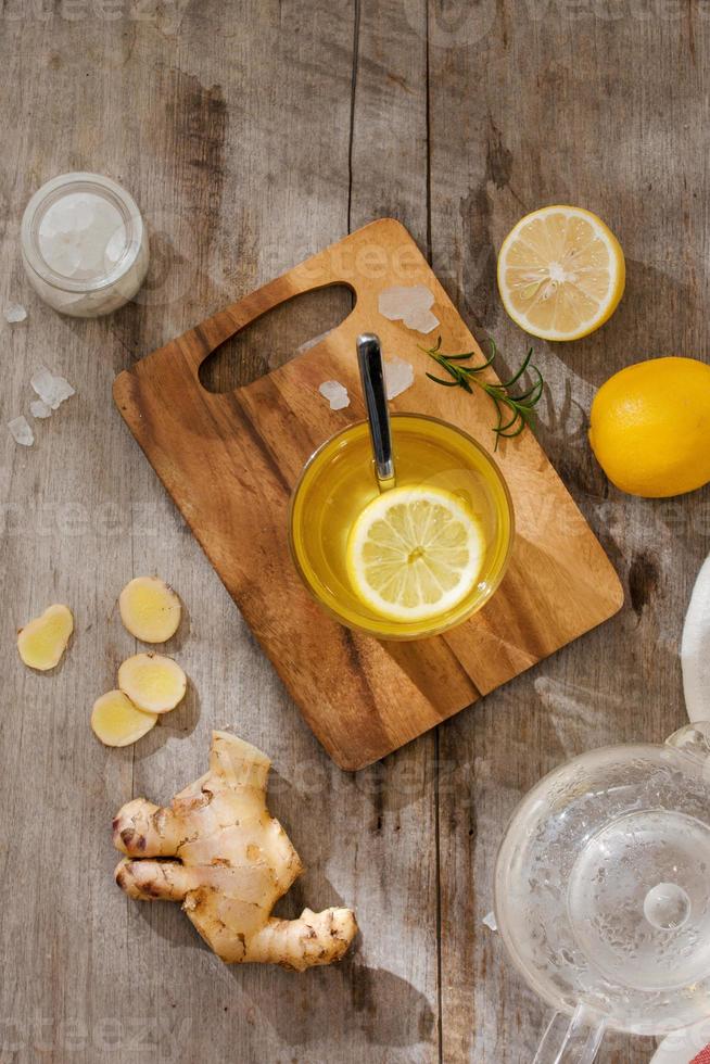 refreshing citrus lemonade,summer drink. Lemonade with fresh lemon on wooden background photo