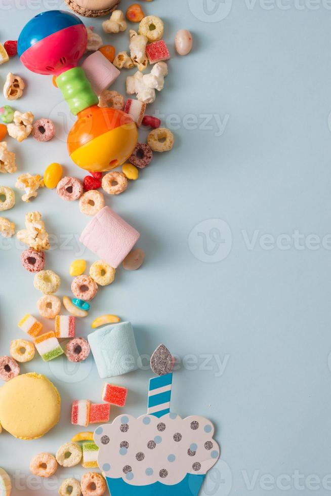 Girl birthday decorations. Blue table setting from above with muffins, drinks and party gadgets. Background layout with free text space. photo