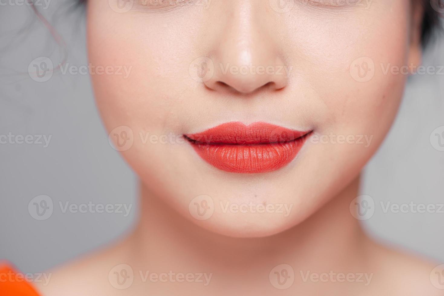 Beautiful curvy feminine lips with coral lipstick photo