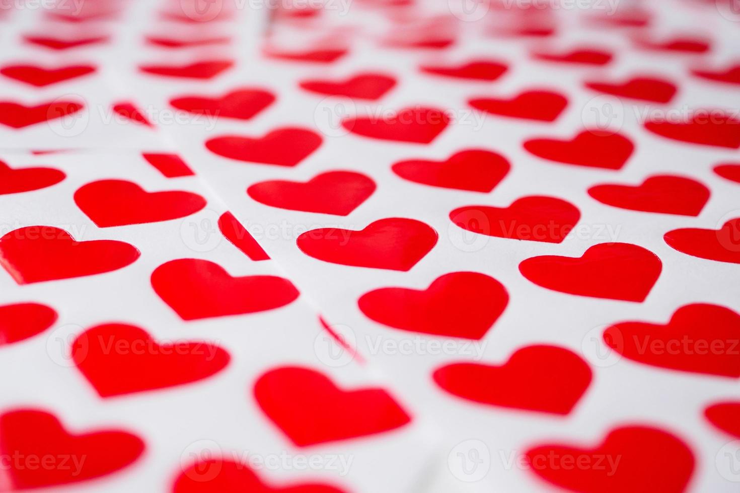 Close up red heart sticker on white paper photo