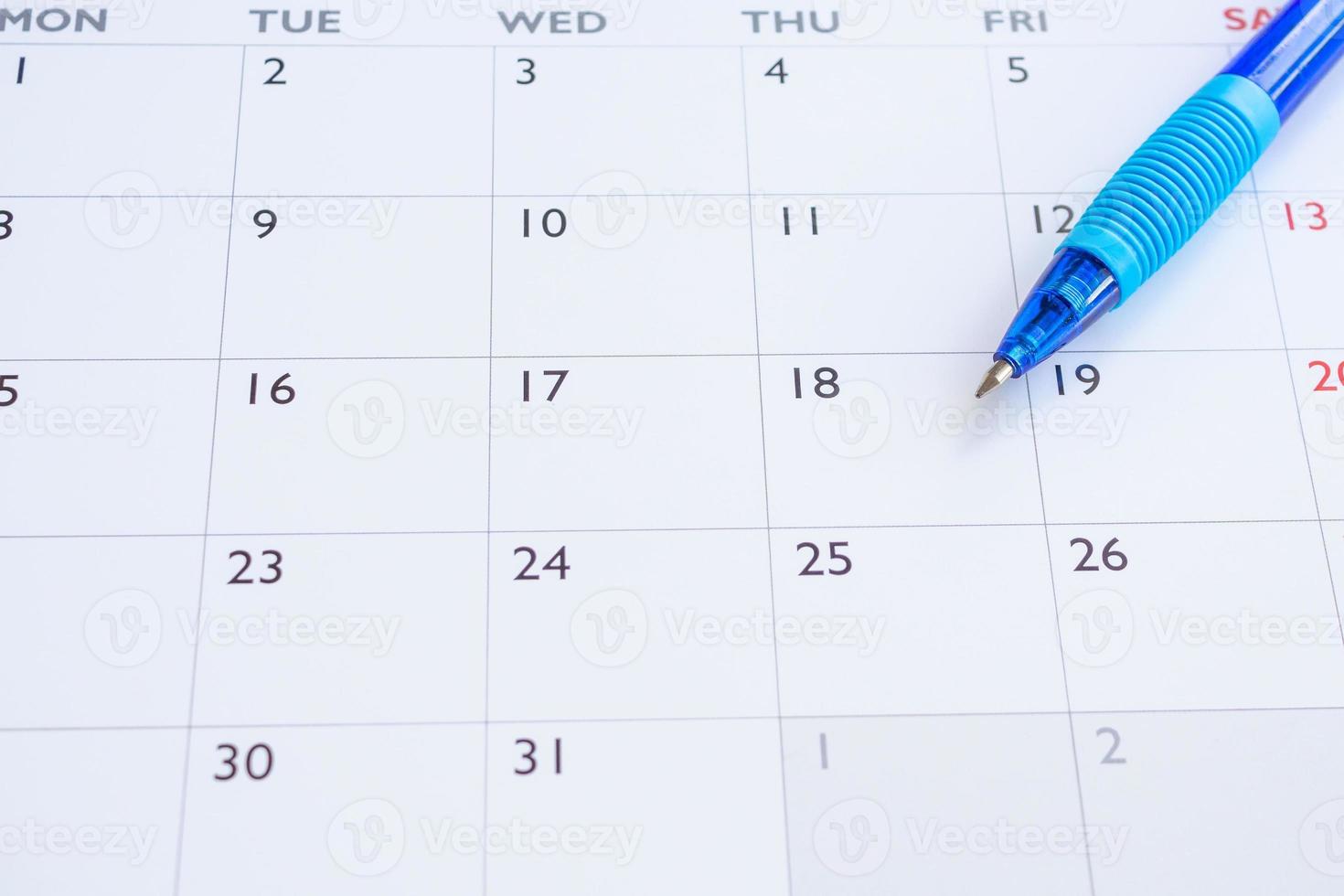 Blue pen on calendar page background business planning appointment meeting concept photo