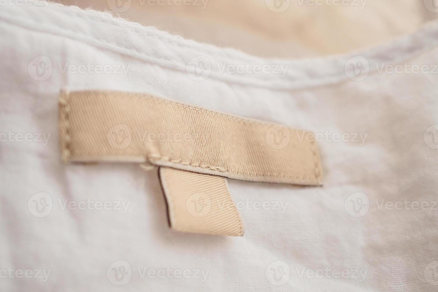 blank clothing label on fabric texture background photo