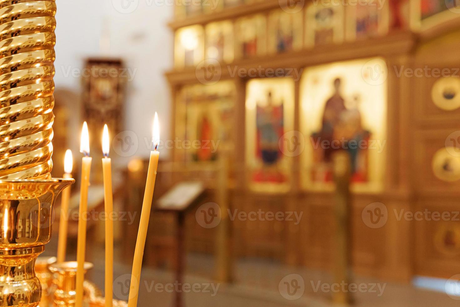 Orthodox Church. Christianity. Festive interior decoration with burning candles and icon in traditional Orthodox Church on Easter Eve or Christmas. Religion faith pray symbol. photo