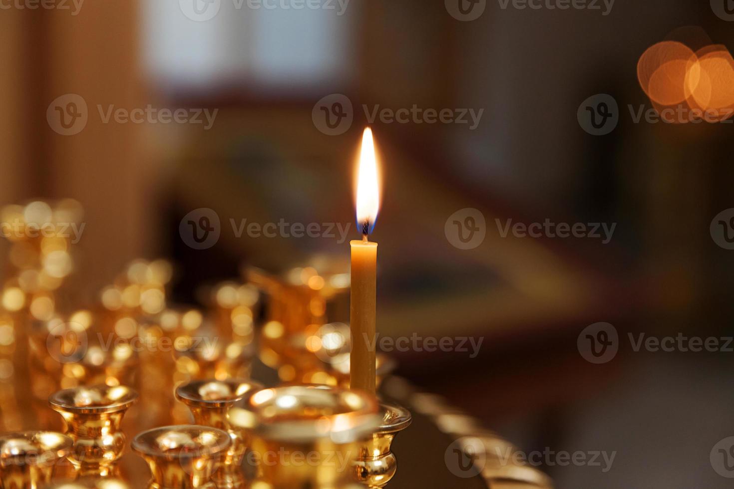Orthodox Church. Christianity. Festive interior decoration with burning candles and icon in traditional Orthodox Church on Easter Eve or Christmas. Religion faith pray symbol. photo