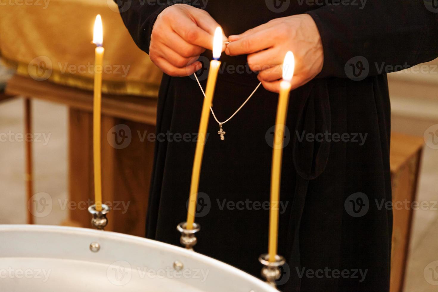 Orthodox Church. Christianity. Priest hands holding cross in traditional Orthodox Church background on wedding day, Easter Eve or Christmas celebration. Religion faith pray symbol photo