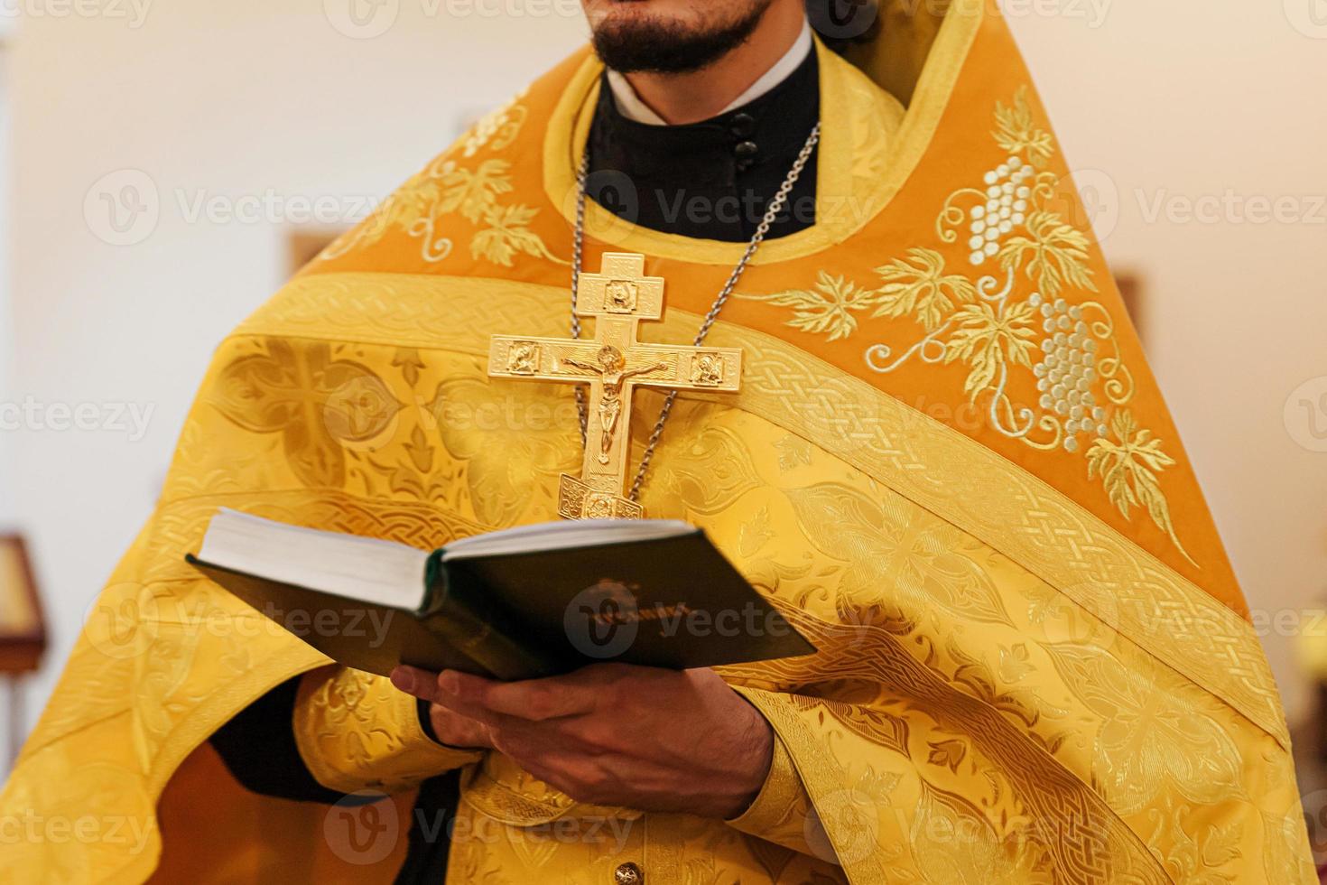 Orthodox Church. Christianity. Priest hands holding Holy Bible book in traditional Orthodox Church background on wedding day, Easter Eve or Christmas celebration. Religion faith pray symbol photo