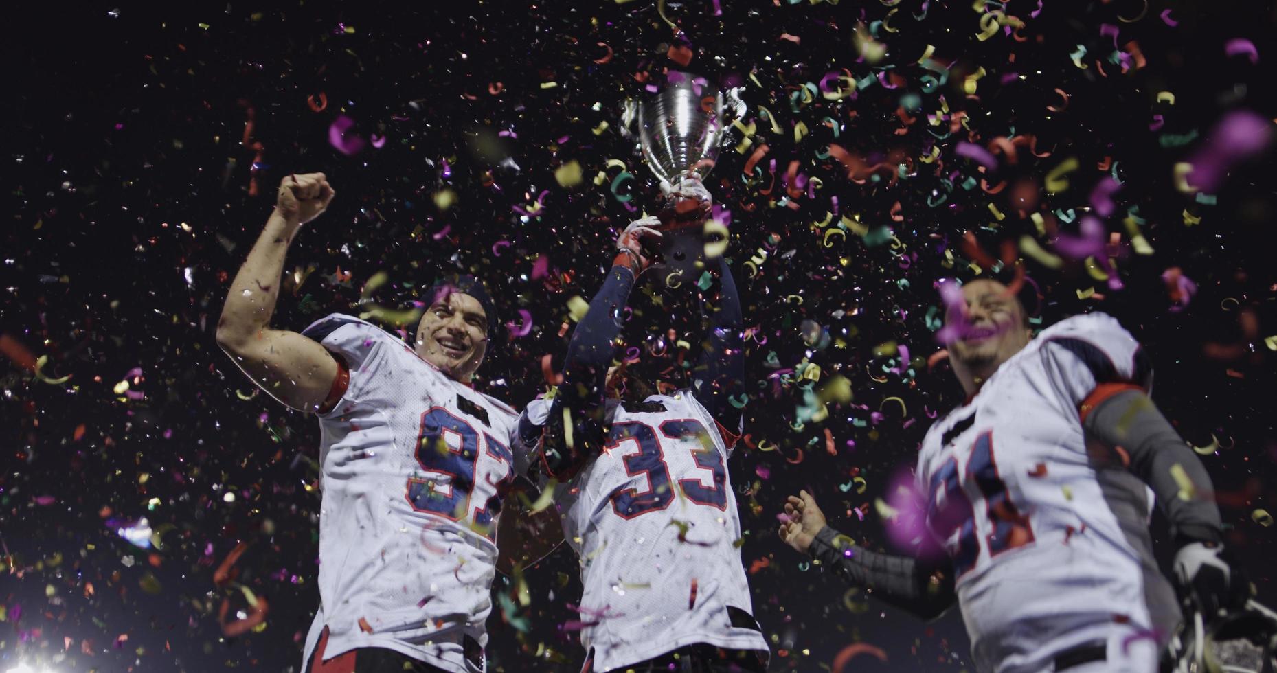 american football team celebrating victory photo