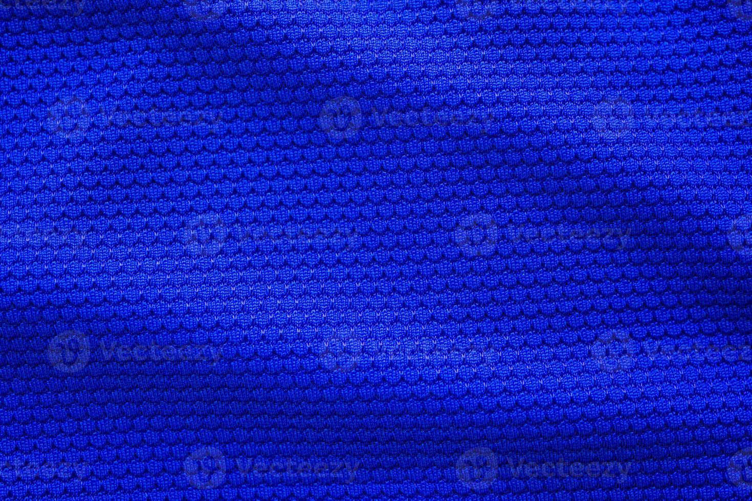 Blue football jersey clothing fabric texture sports wear background, close up top view photo