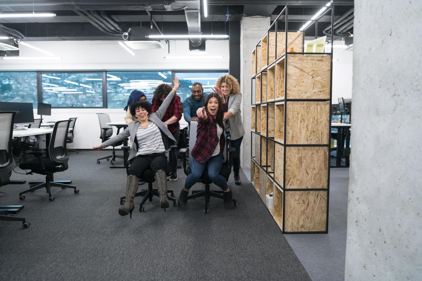 multiethnics business team racing on office chairs photo