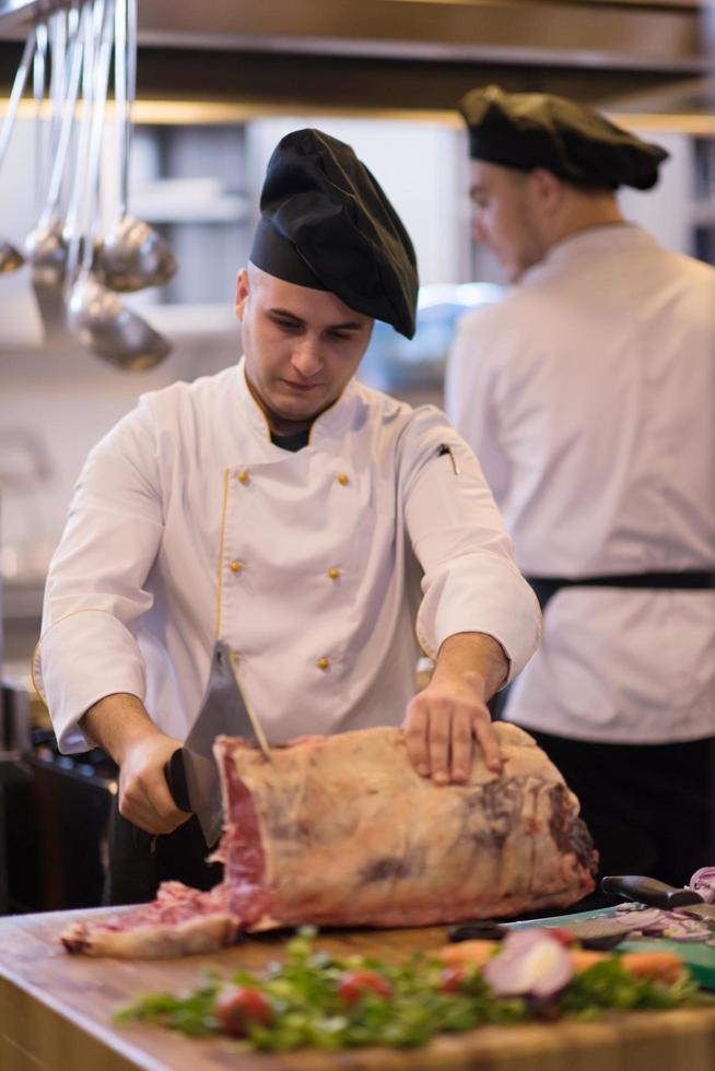 chef cutting big piece of beef photo