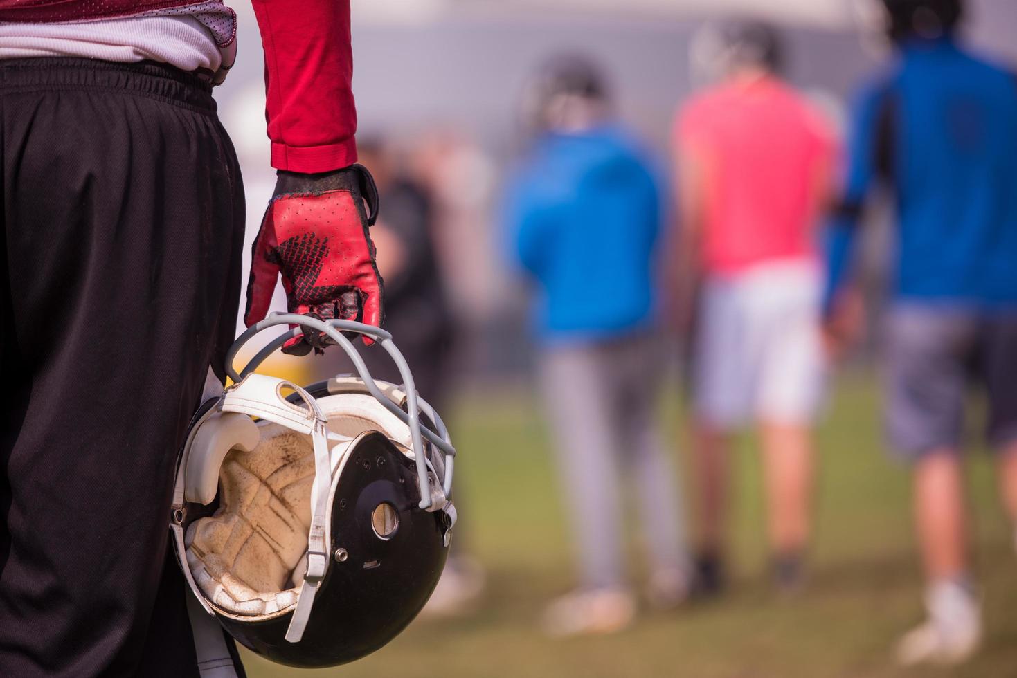 American football player holding helmet photo