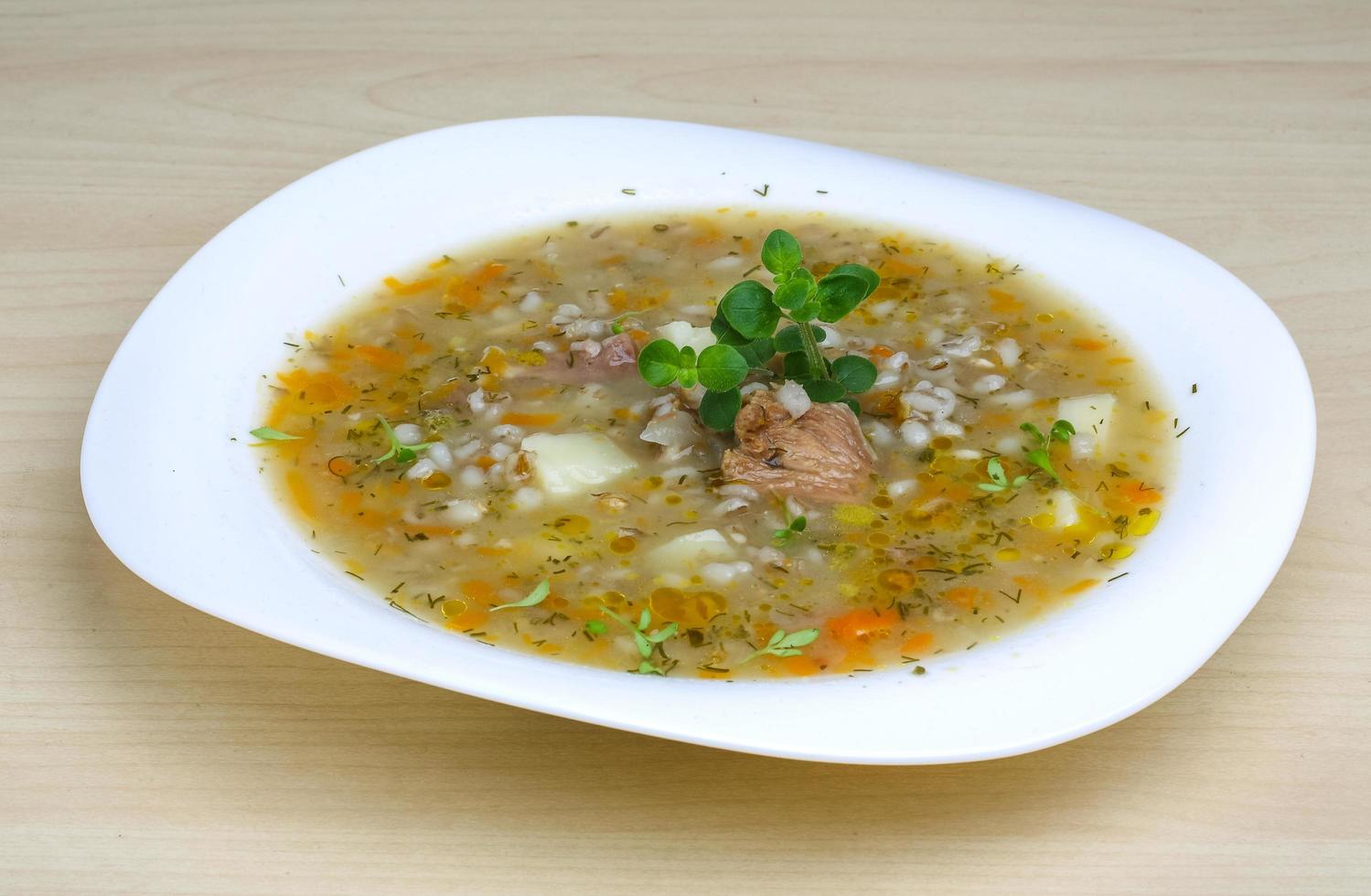 Cereal soup on the plate and wooden background photo