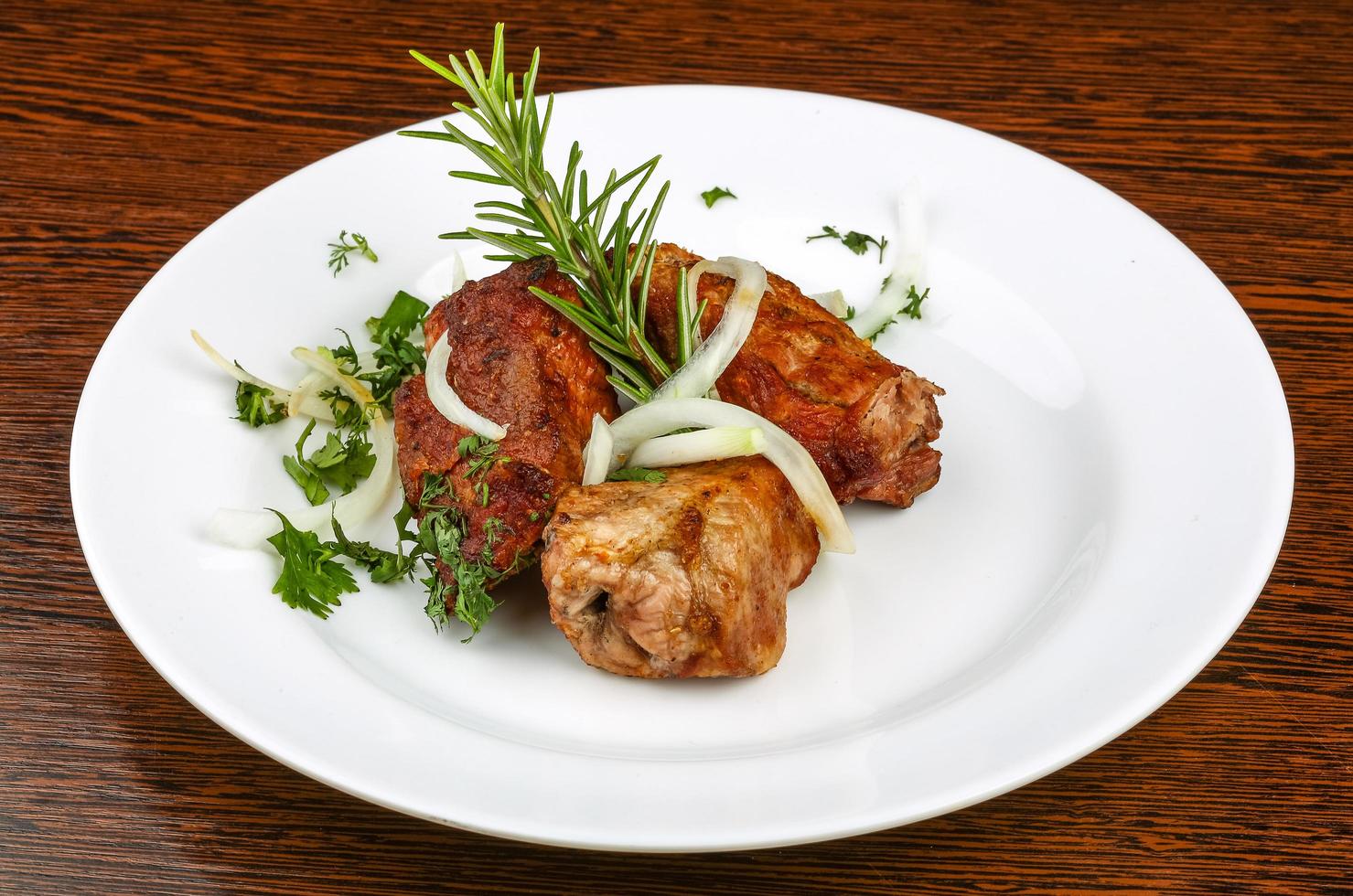 Shashlik on the plate and wooden background photo