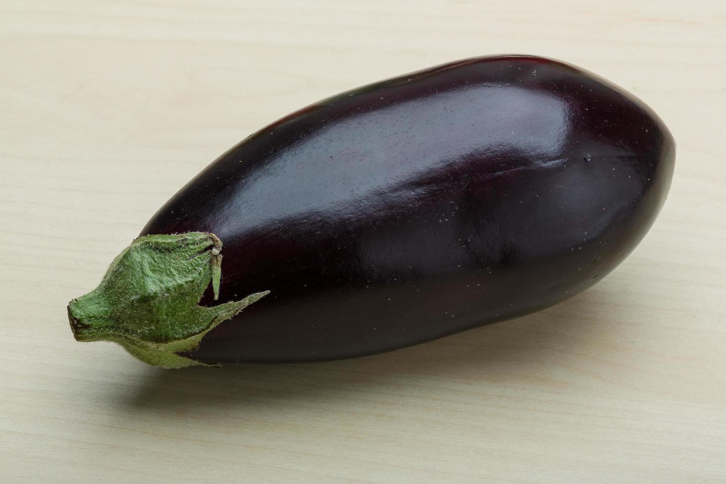 Eggplant on wooden background photo