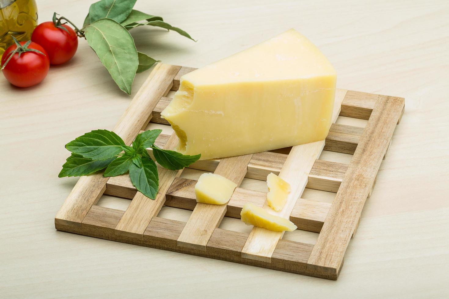 Parmesan cheese on wooden board and wooden background photo
