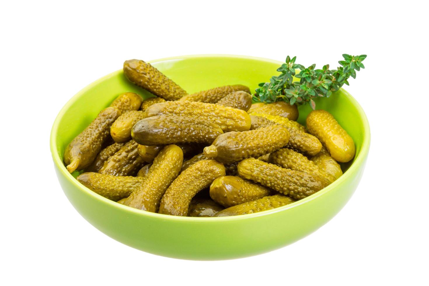 Marinated cucumbers on white photo