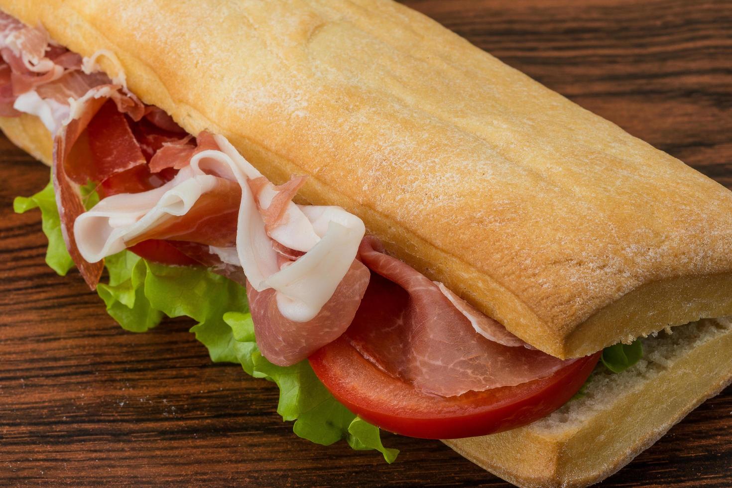 Ham sandwich on wood photo