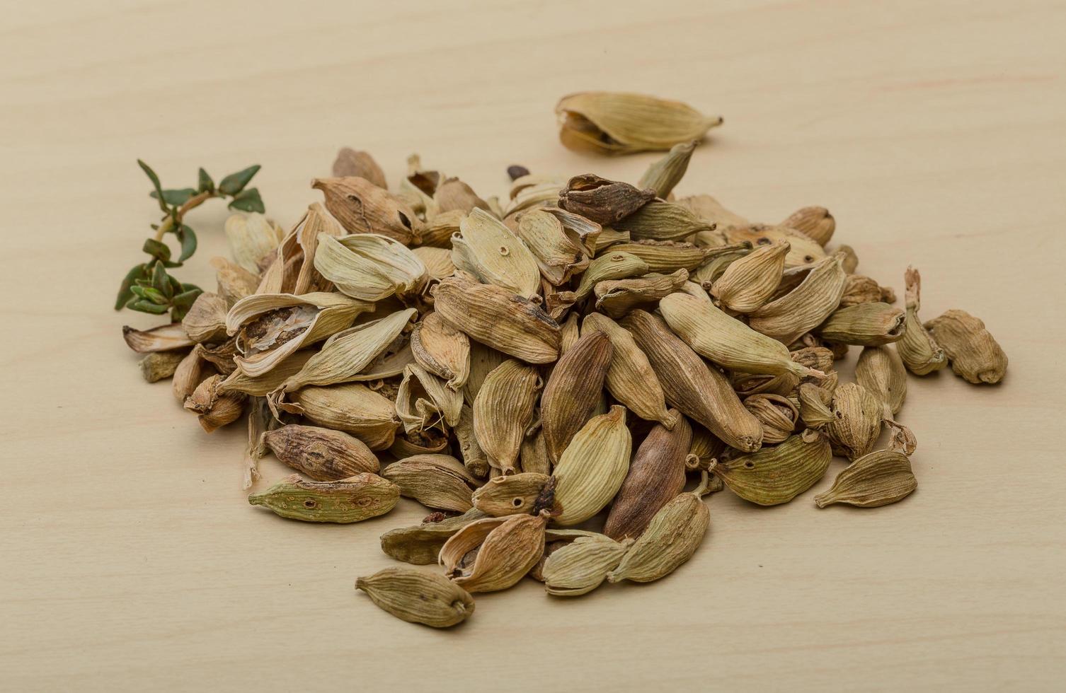 Cardamom on wooden background photo