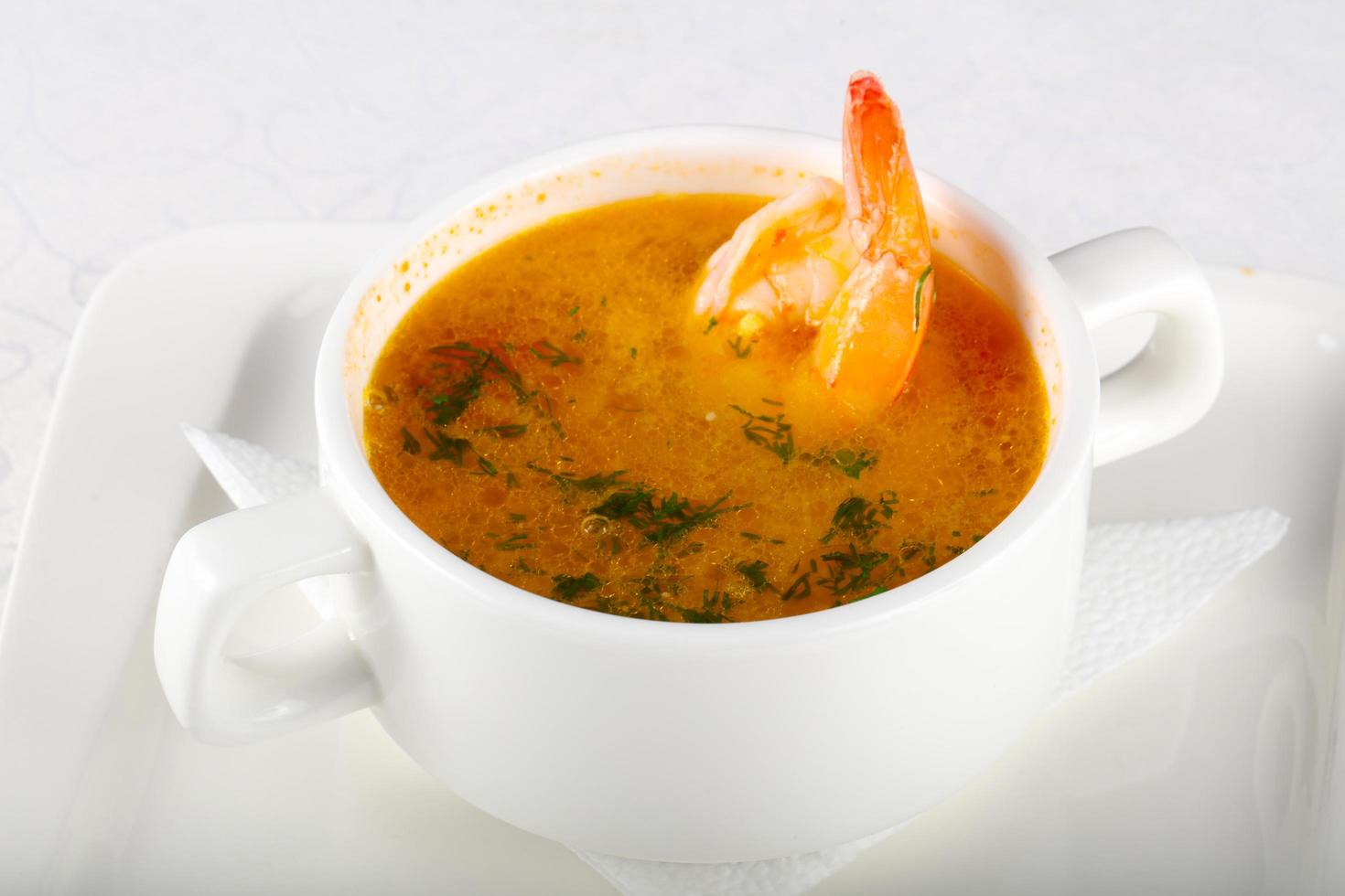 Prawn soup in a bowl on white background photo