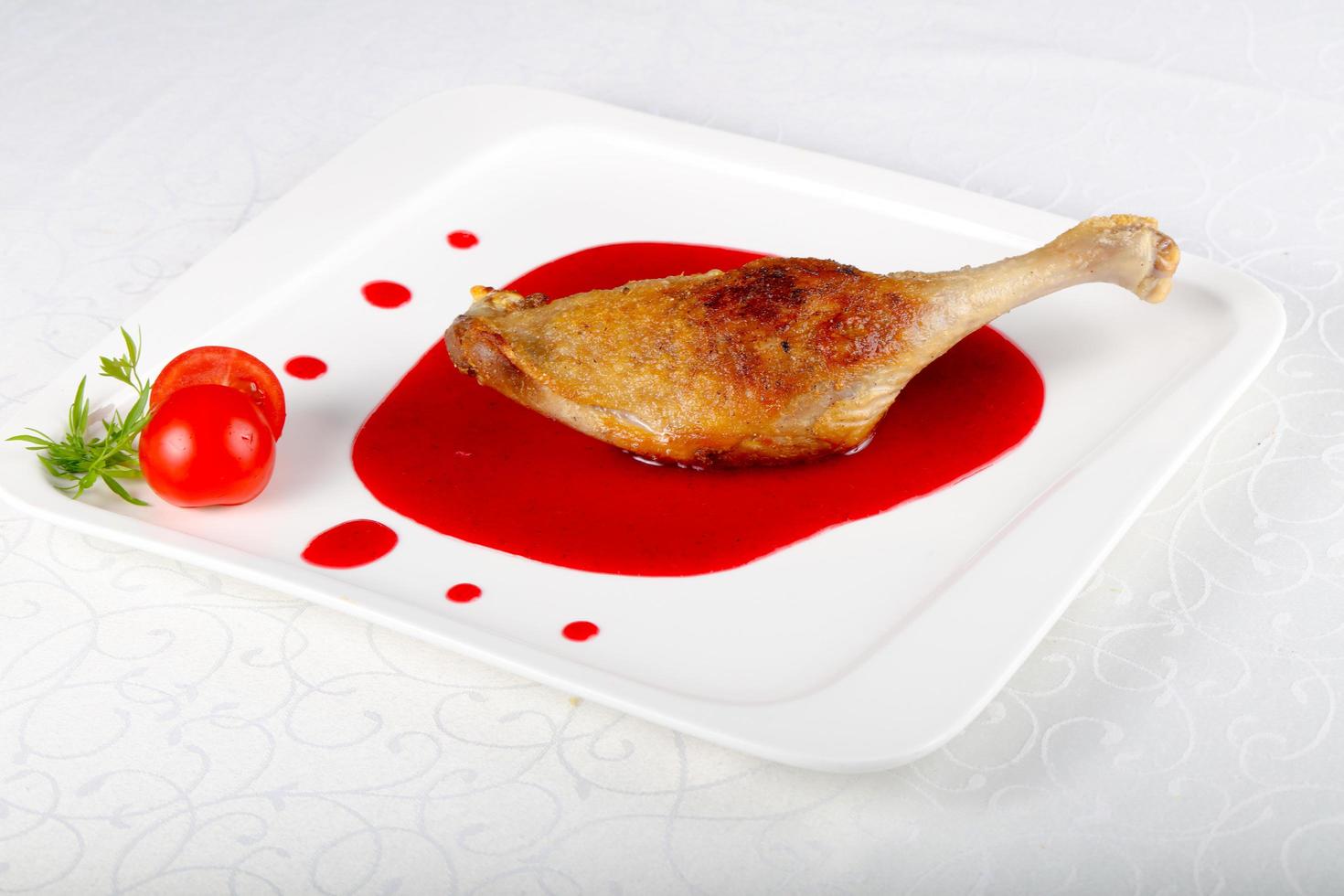 Duck leg on the plate and white background photo
