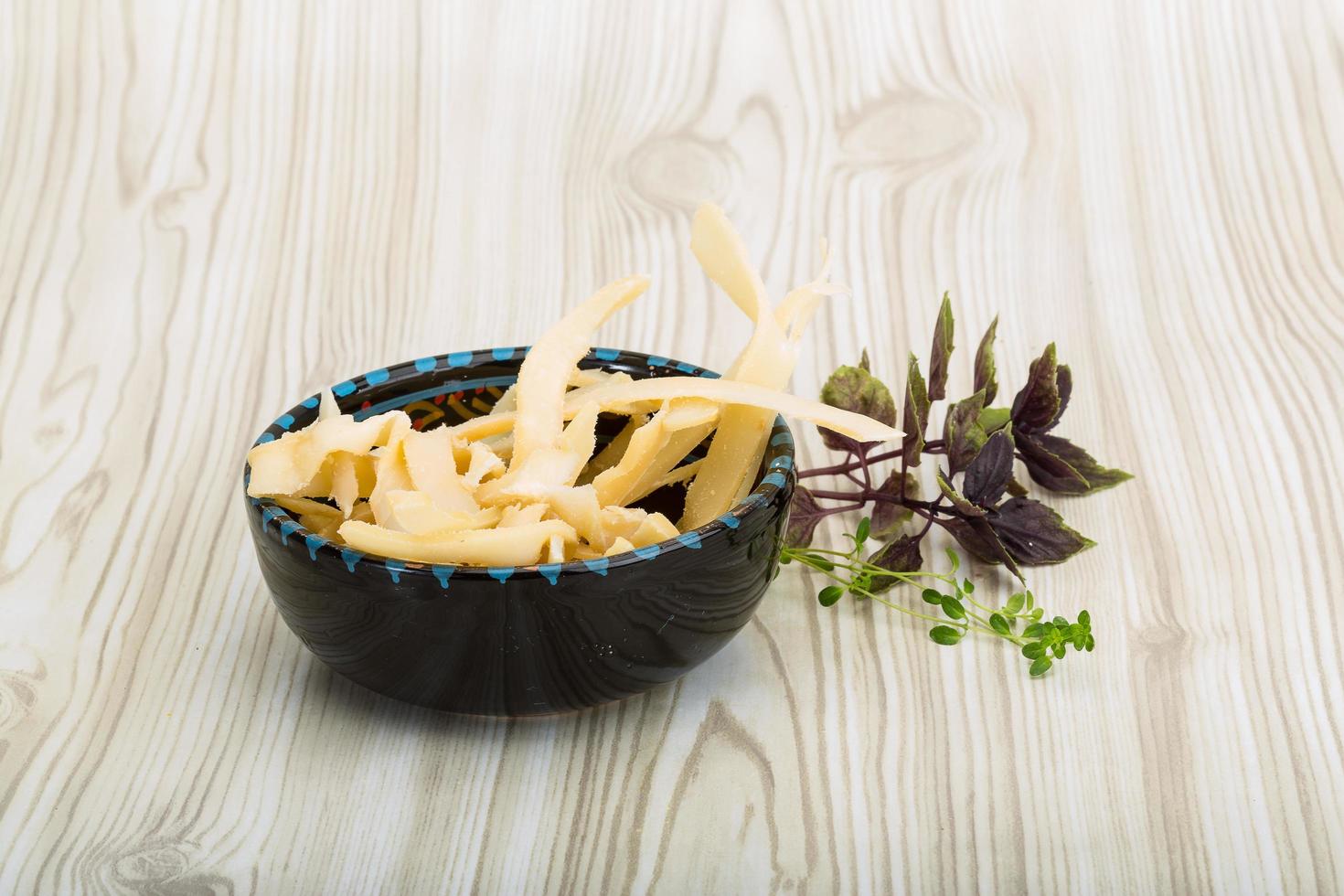 Dried squids in a bowl on wooden background photo