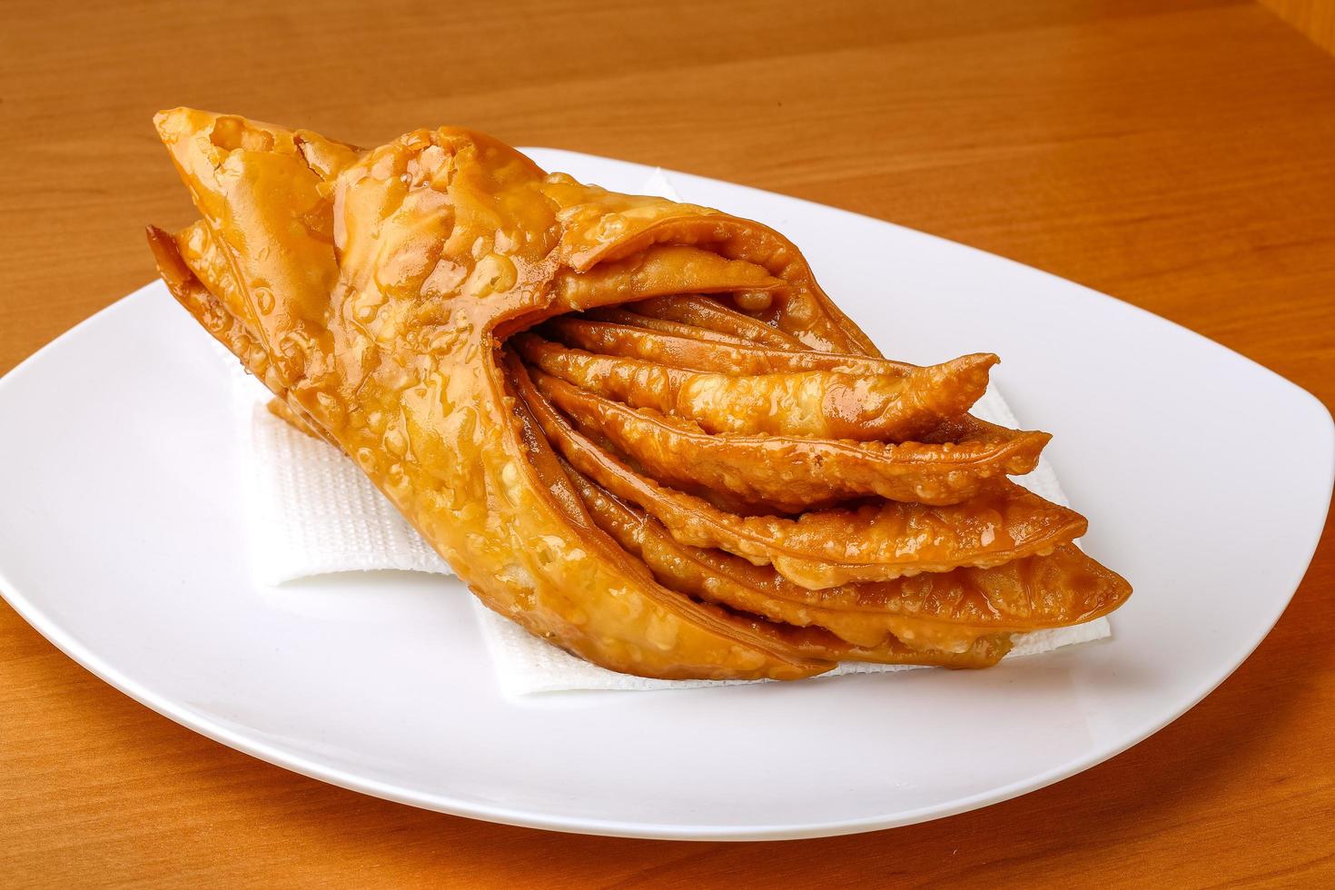 Baklava on the plate and wooden background photo