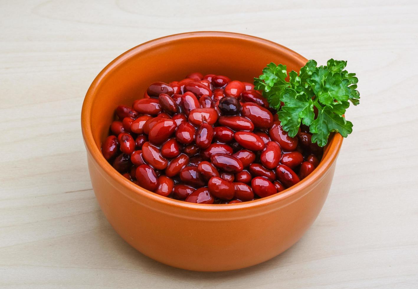 Baked beans in a bowl on wooden background photo