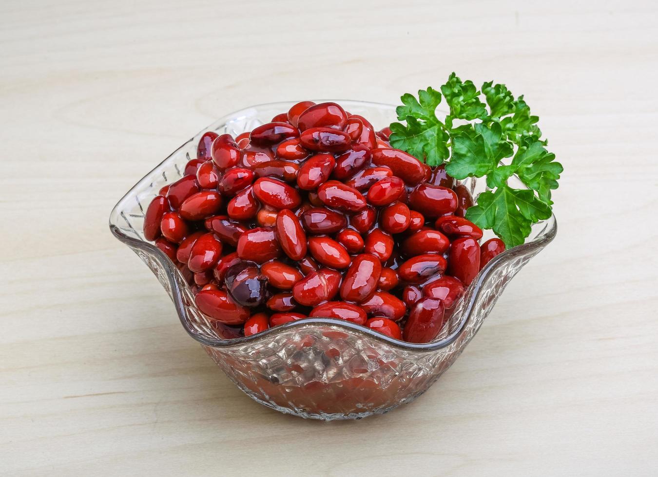 Canned beans in a bowl on wooden background photo