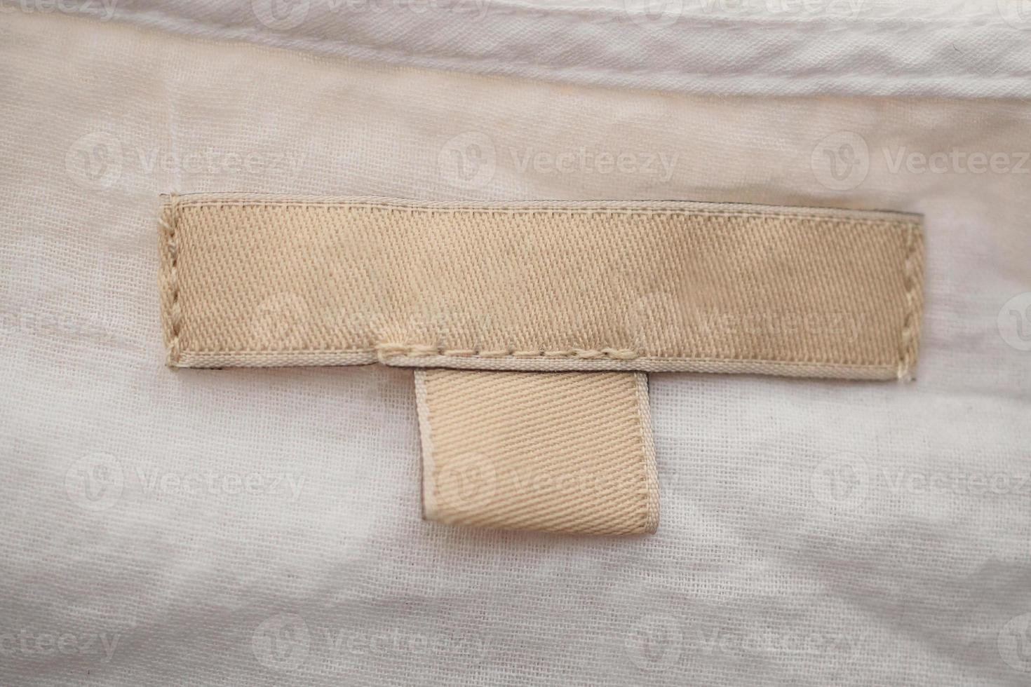 blank clothing label on fabric texture background photo