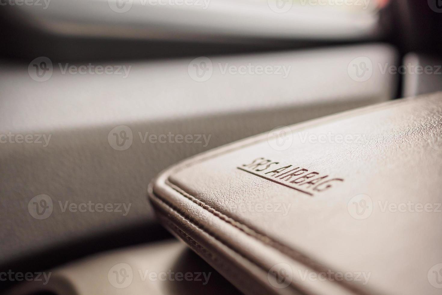 airbag safety sign on brown leather texture in modern car photo