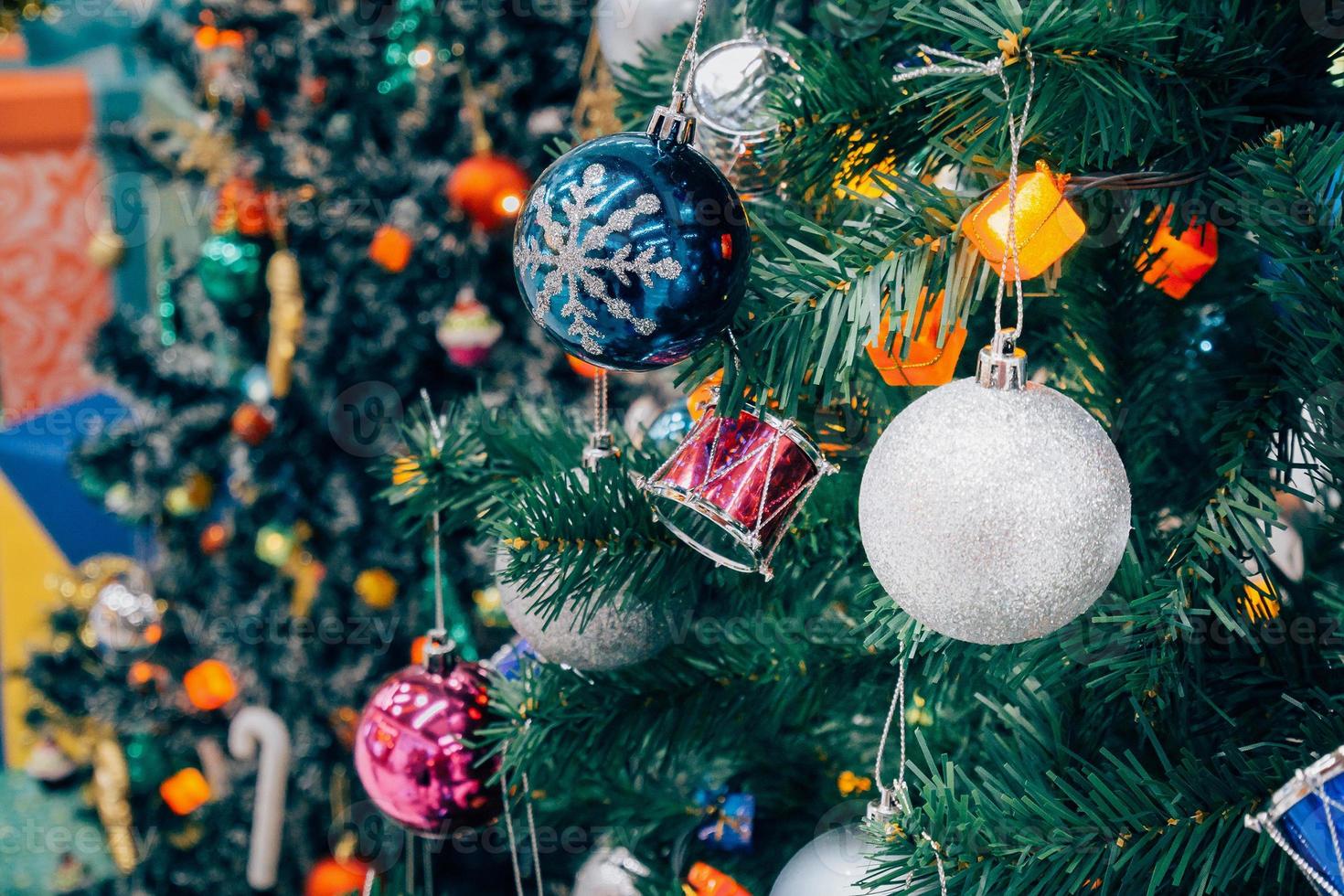 Decorated Christmas tree with colorful bauble on sparkling bokeh light blurred background photo