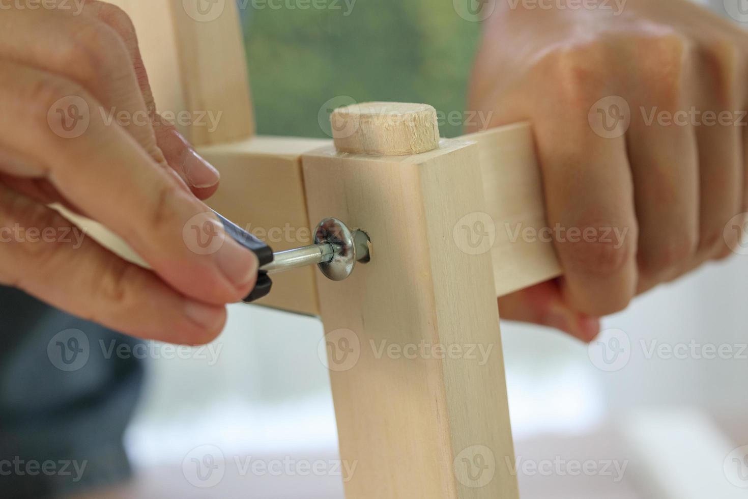 Assembly wooden furniture at home using screw allen photo