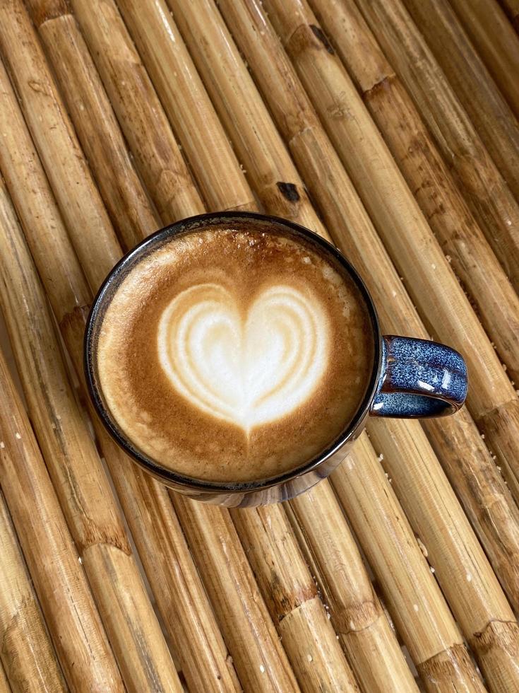 Heart latte art on coffee cup photo