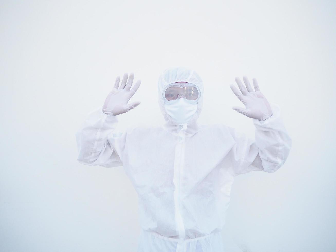 Asian male doctor or scientist in PPE suite uniform showing stop sign while looking ahead. coronavirus or COVID-19 concept isolated white background photo