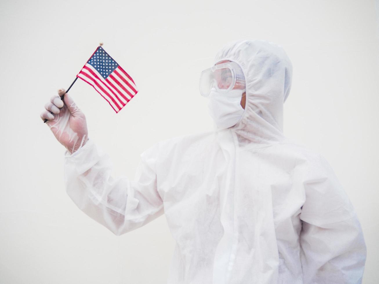 Portrait of doctor or scientist in PPE suite uniform holding national flag of United states of America. COVID-19 concept isolated white background photo