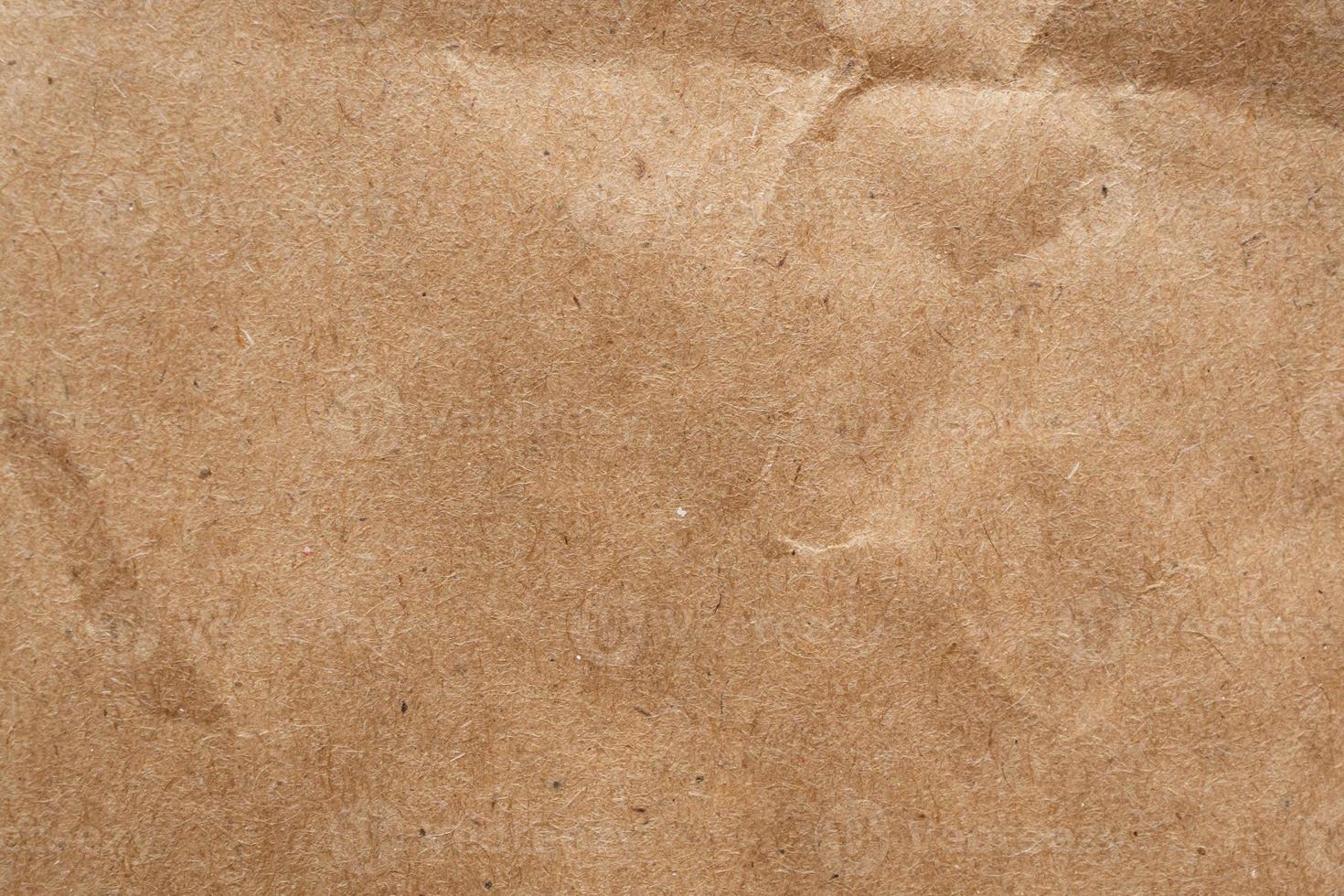 Brown crumpled paper recycled kraft sheet texture background photo