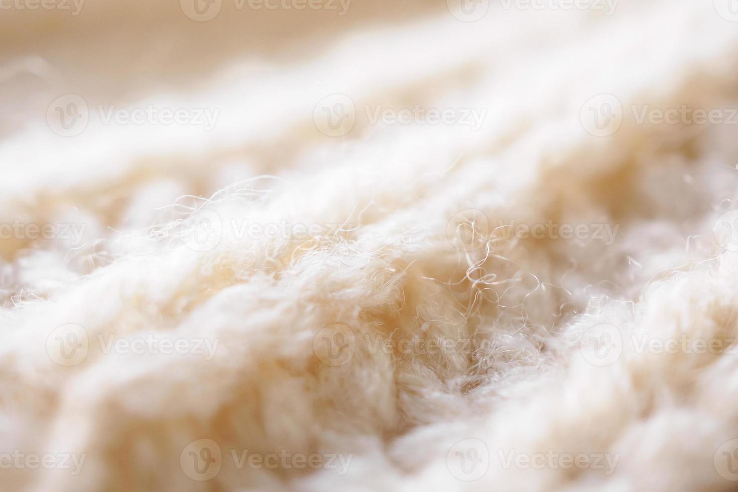 closeup beige knitted woolen fabric texture background photo